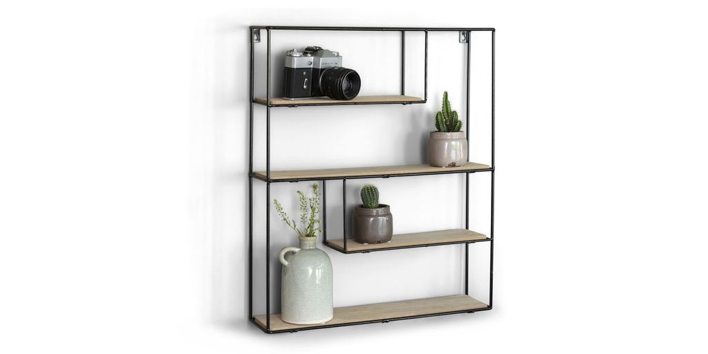 A rectangular wall shelf with four wooden shelves and a black metal frame, decorated with a camera, two potted plants, and a vase with dried flowers.