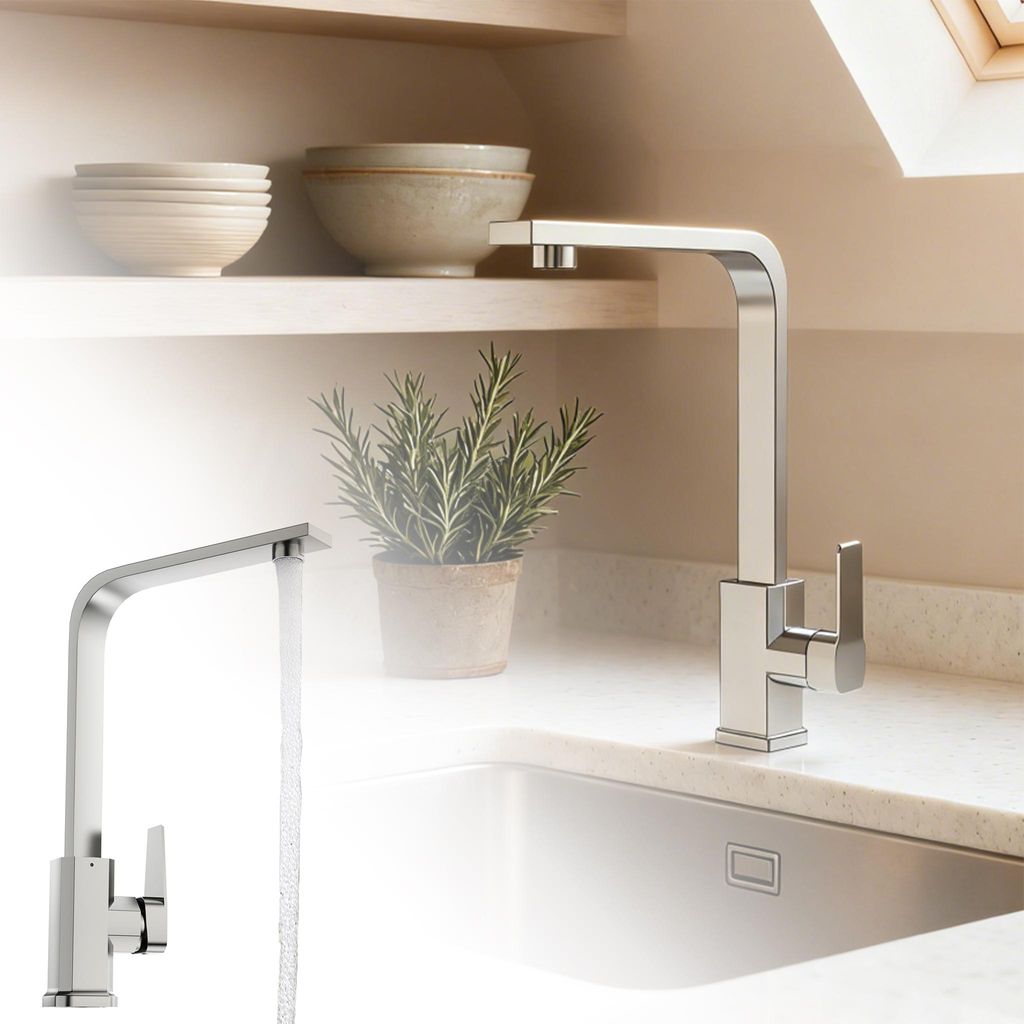 A modern kitchen sink with a chrome faucet and a potted rosemary plant on the counter.