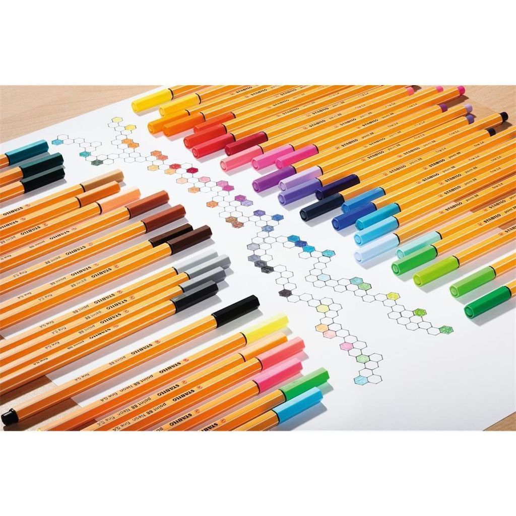 A collection of STABILO point 88 fineliner pens arranged on a white surface with a honeycomb-like pattern drawn on it.