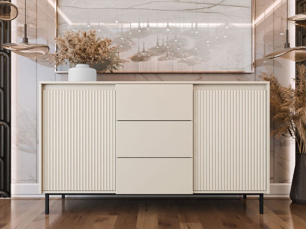 A modern sideboard with fluted doors and drawers, set against a marble-patterned wall with abstract art above.