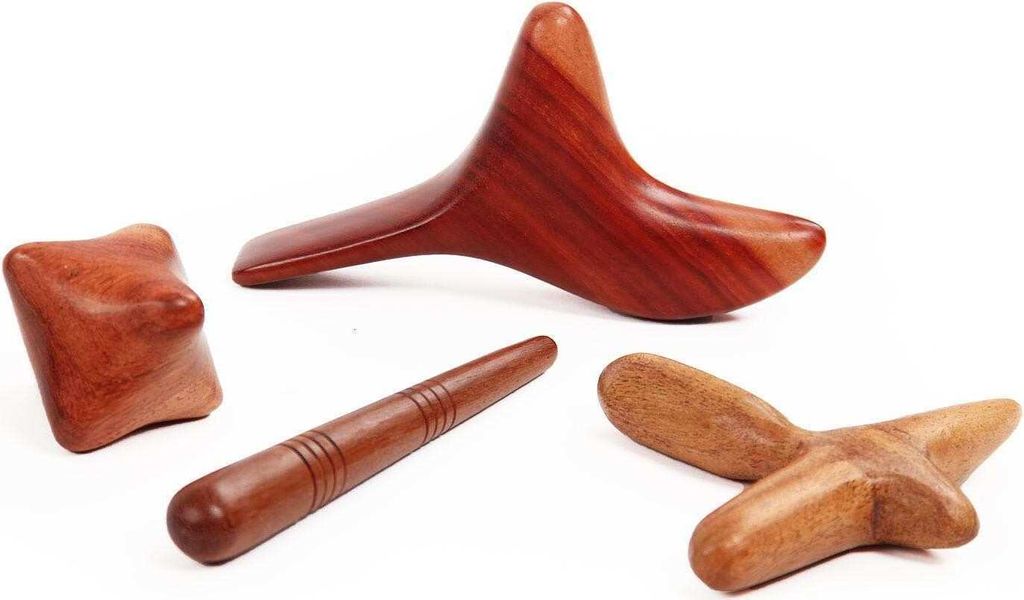 A collection of wooden massage tools arranged on a white background.