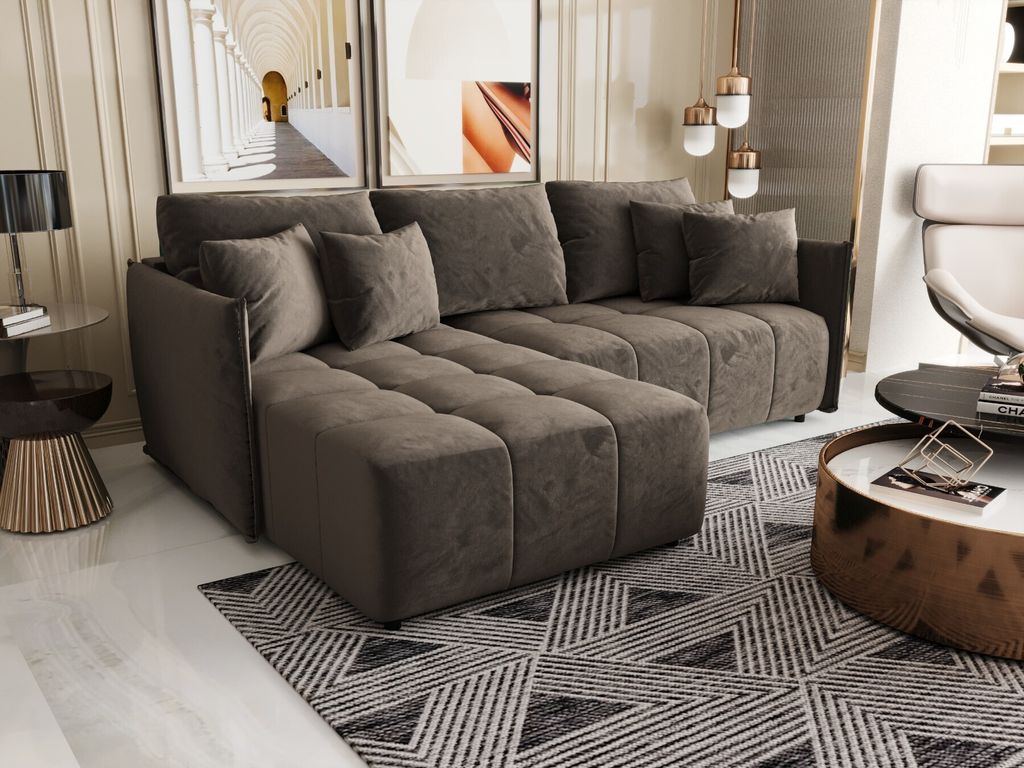 A modern living room with a sectional sofa, coffee table, and artwork.