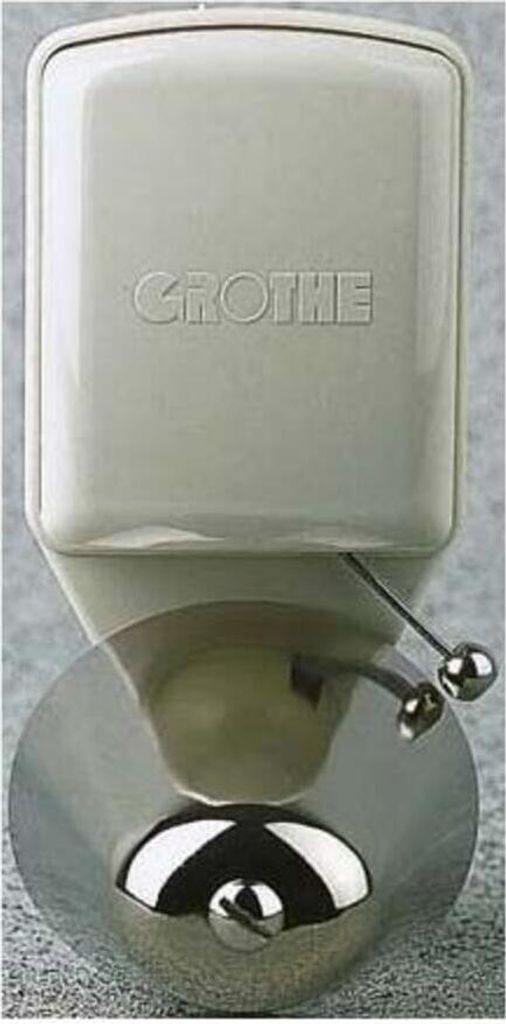 A close-up, front-facing view of a white Grothe doorbell with a chrome bell.