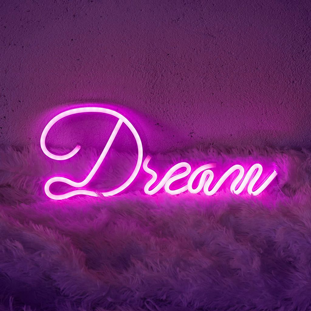 A pink neon sign spelling 'Dream' is mounted on a textured purple wall above a fluffy white and purple rug.