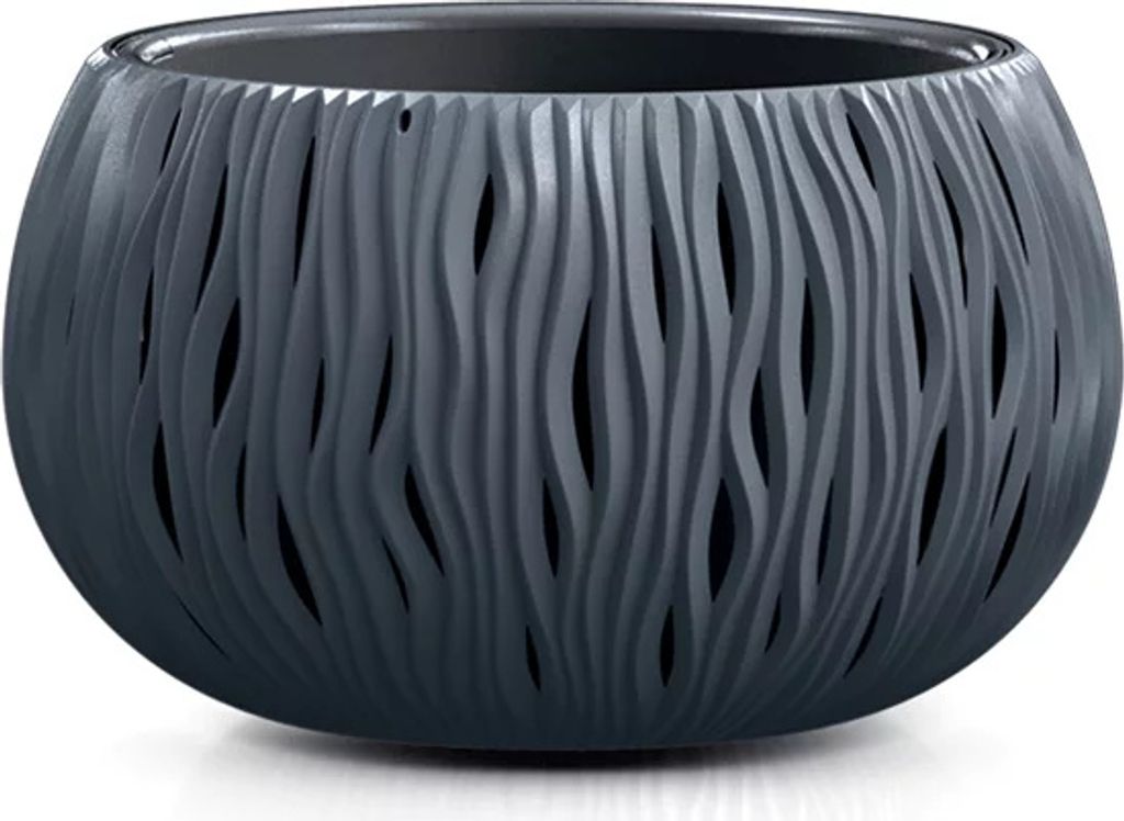 A dark gray, round planter with a wavy, cut-out pattern sits on a white surface.