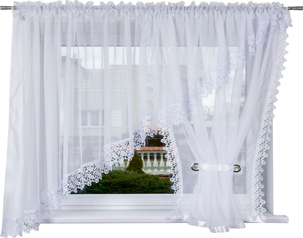 A white lace curtain is shown hanging in a window.