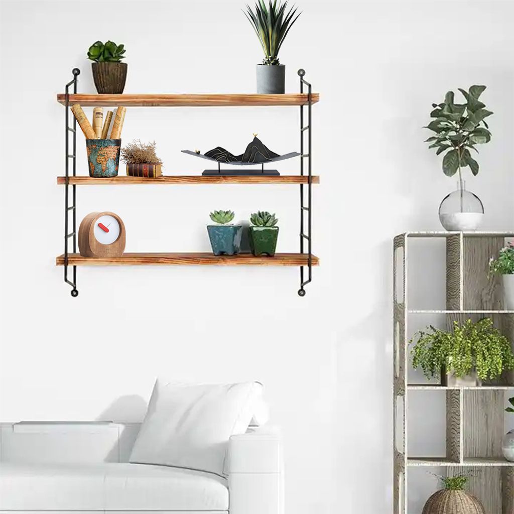 A three-tiered wooden shelf with various decorative items and plants.