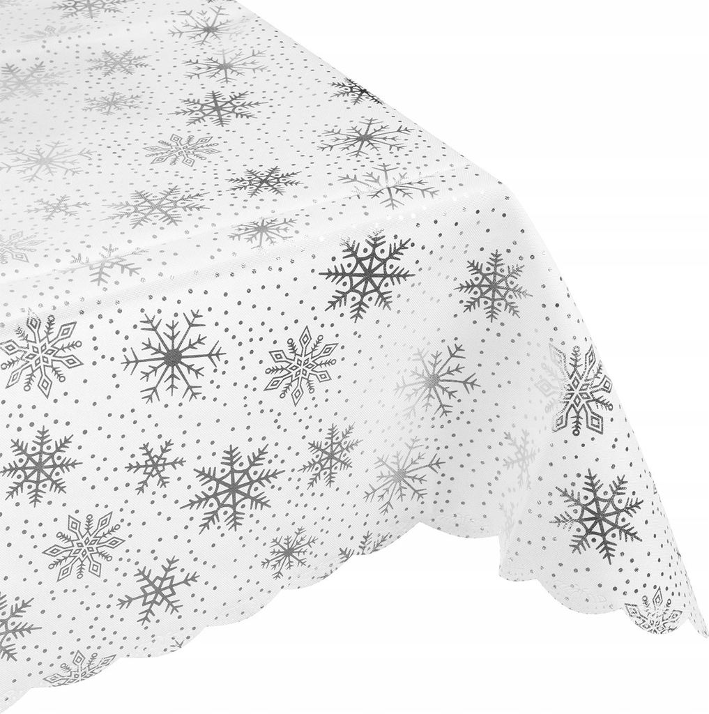 A close-up, angled view of a white tablecloth with a silver snowflake pattern.