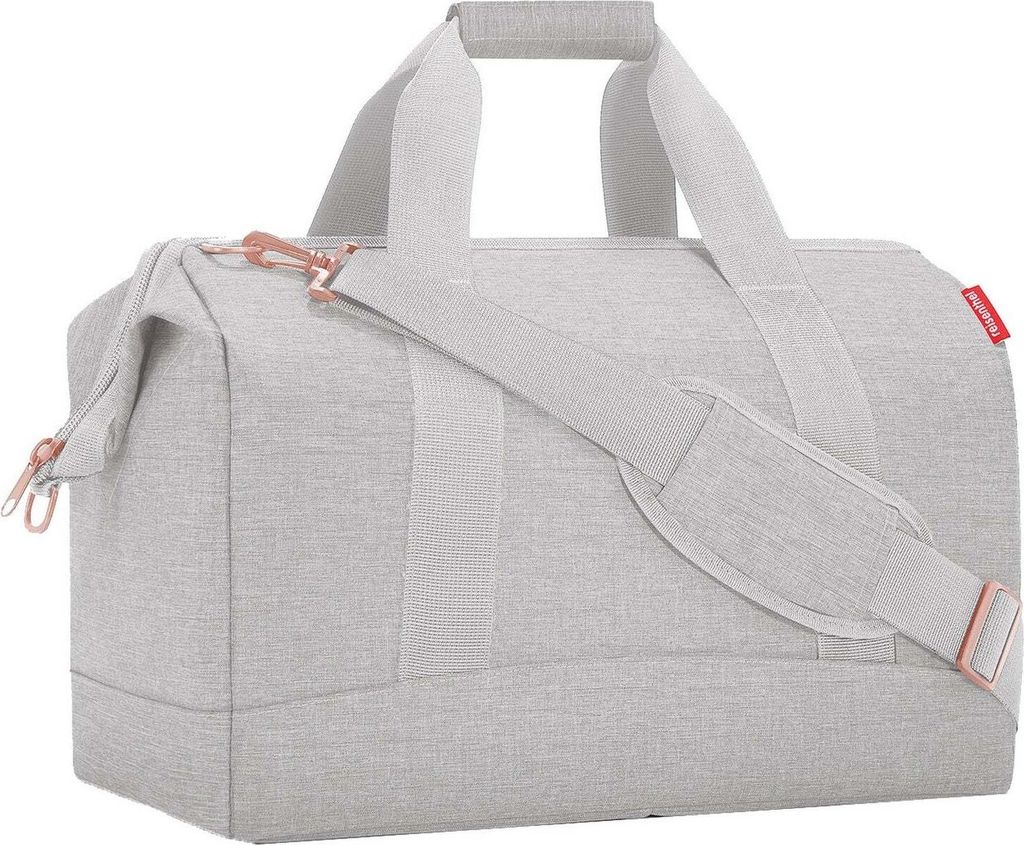A light gray duffel bag with rose gold accents is shown against a white background.