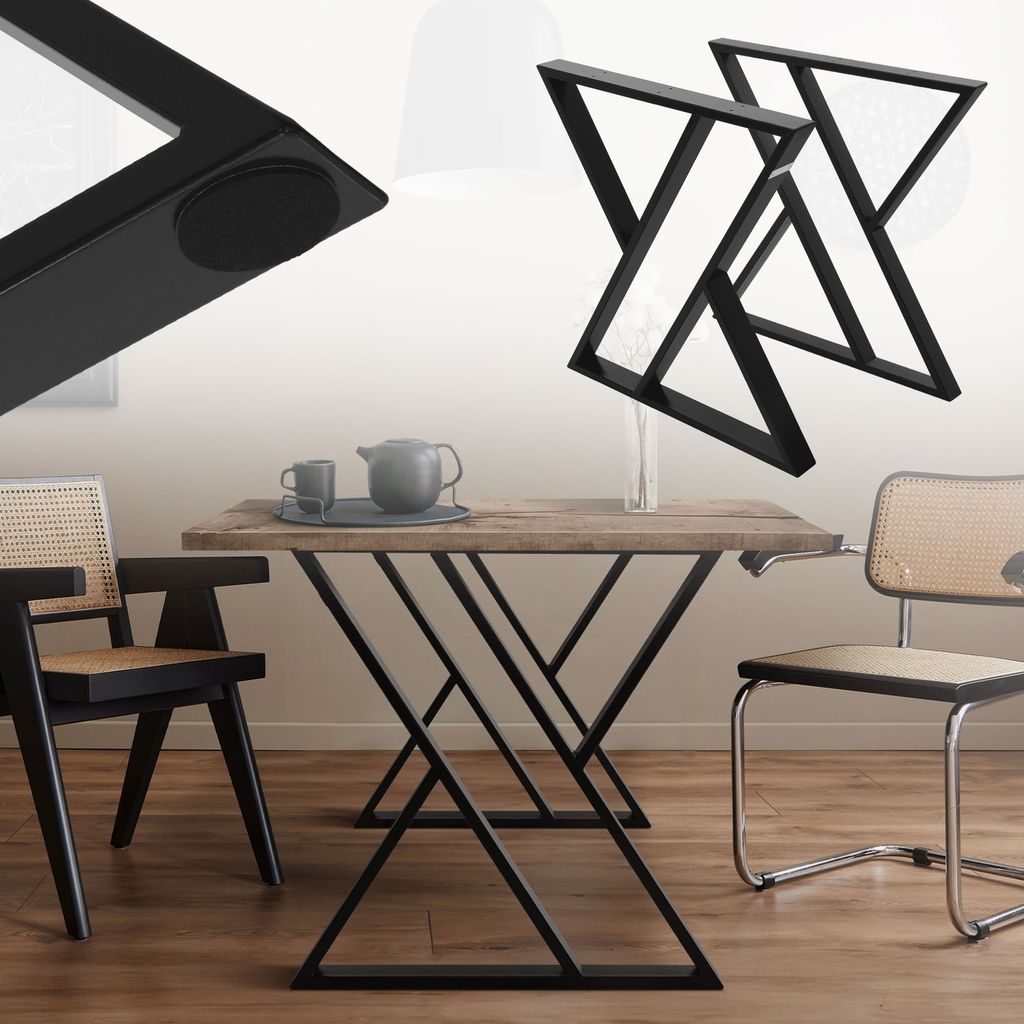 A dining table with black metal legs and a wooden top, set with a teapot and cups. Two chairs are visible, one black and one chrome with cane seating. Two additional table legs are shown in the upper right corner.