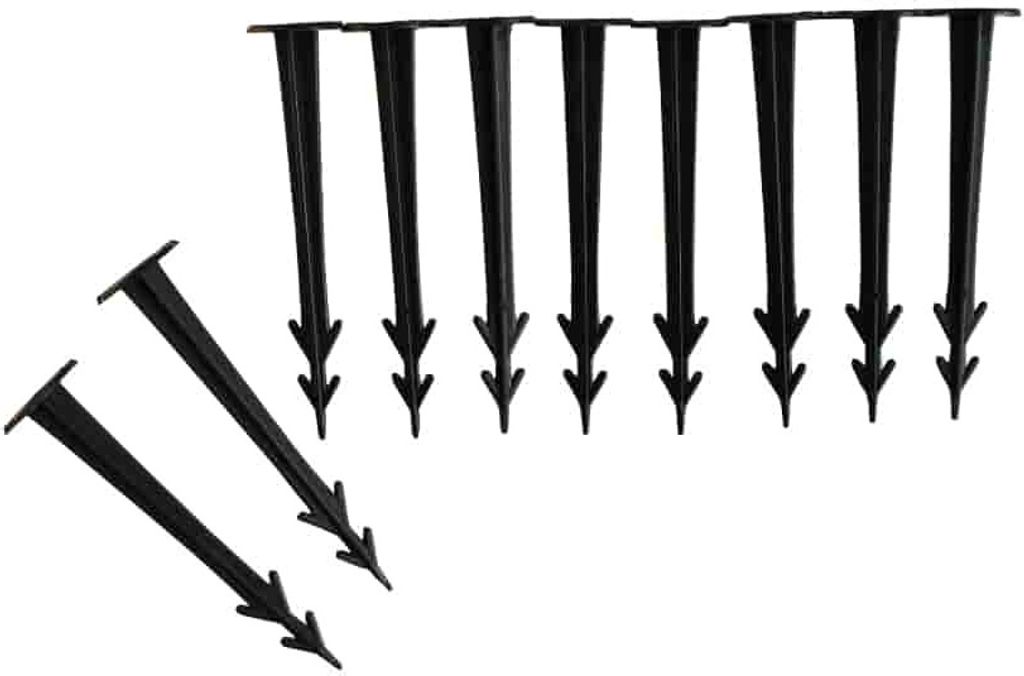 A group of black plastic ground stakes arranged on a white background.