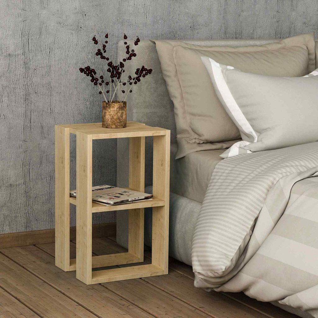 A bedside table next to a bed in a bedroom.