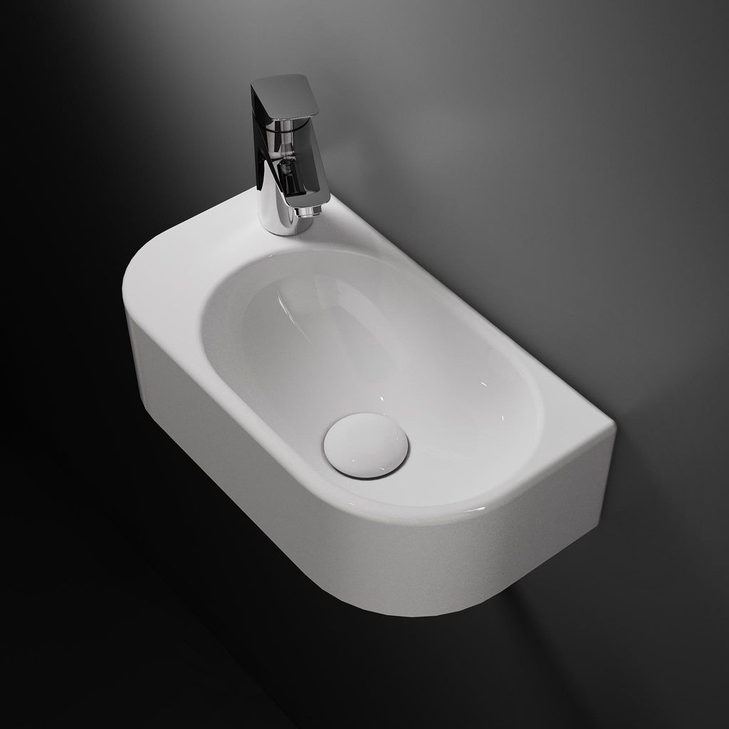 A white wall-mounted sink with a chrome faucet against a dark gray wall and black floor.