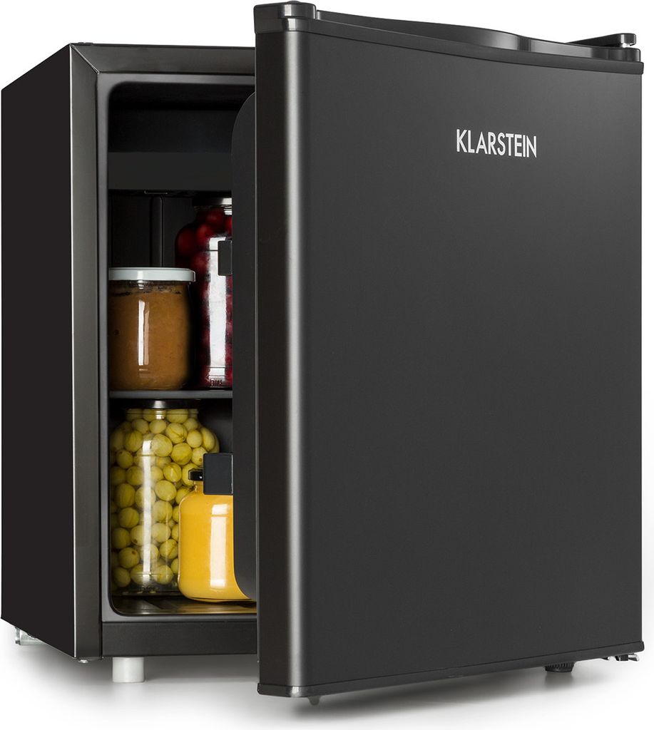 A black mini-fridge with its door open, showing jars of food and a bottle of juice inside. The brand name is visible on the door.