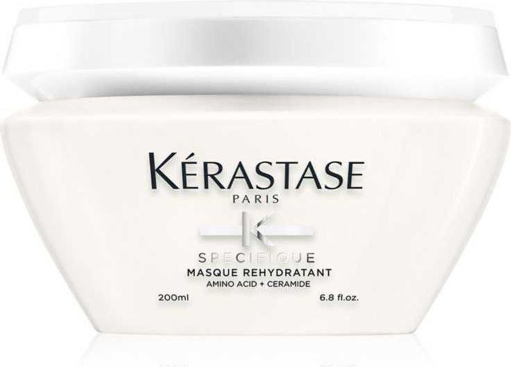 A white jar of Kérastase hair mask is shown against a white background.