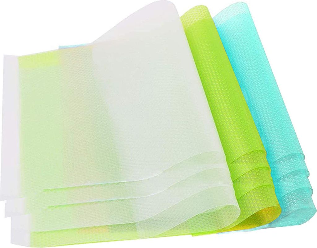 Three rolled-up mats in different colors (white, green, and cyan) with a honeycomb pattern.