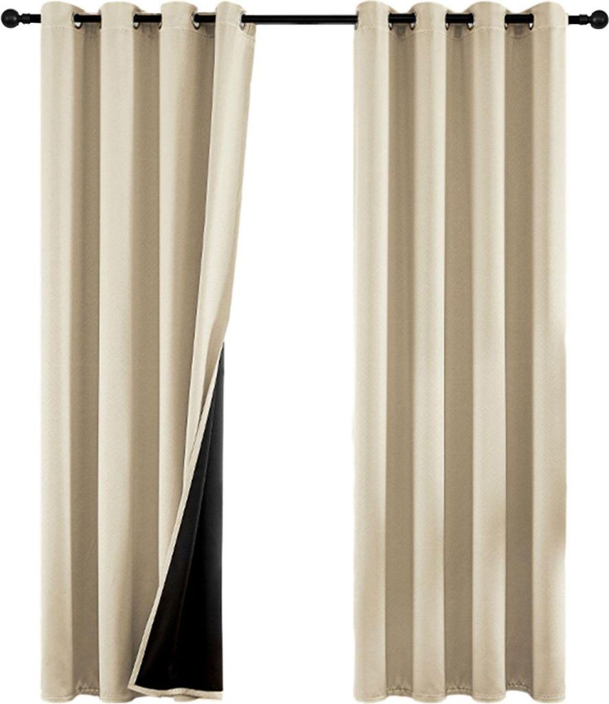 Two beige curtains hanging from a curtain rod, with one curtain pulled back to reveal a black lining.