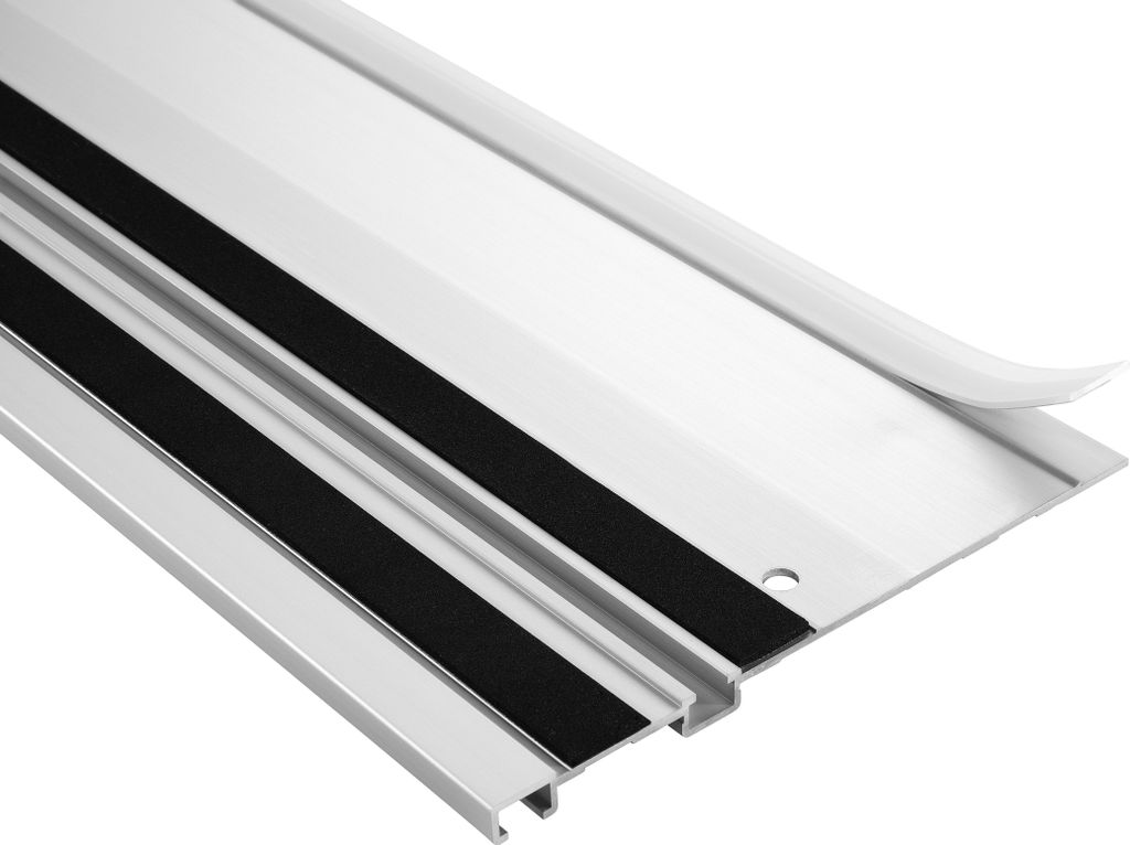 A close-up view of a silver aluminum track saw guide rail with black anti-slip strips.