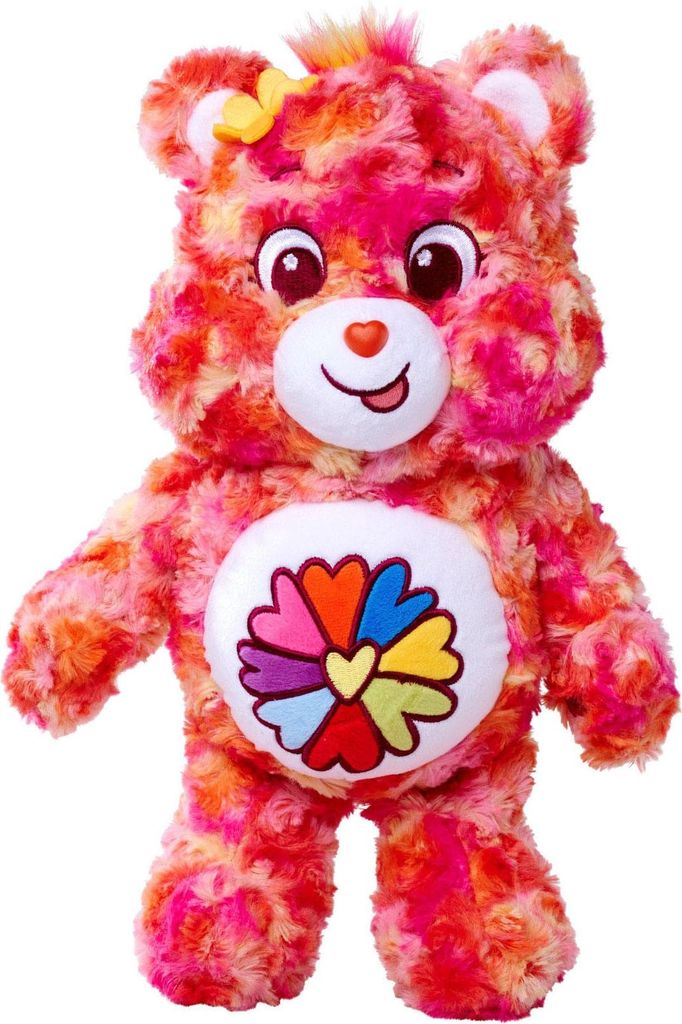 A stuffed toy bear with a colorful tie-dye pattern and a flower symbol on its belly.
