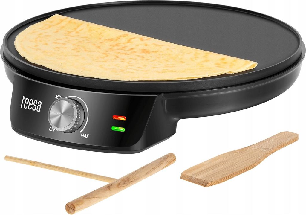 A black electric crepe maker with a crepe on it, and two wooden accessories below.
