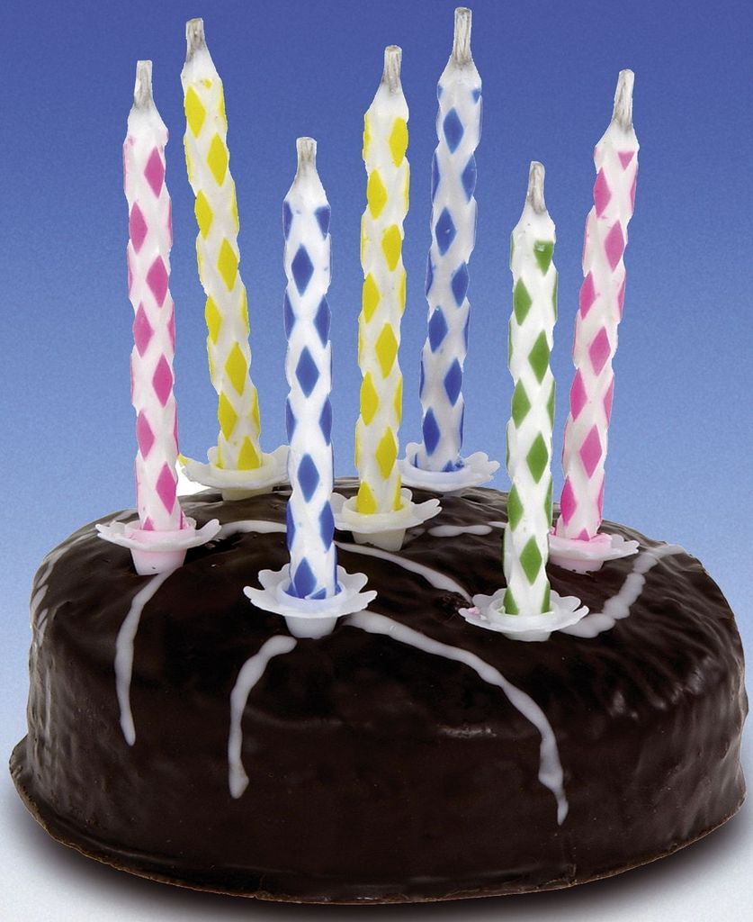A close-up of a chocolate cake with colorful birthday candles.