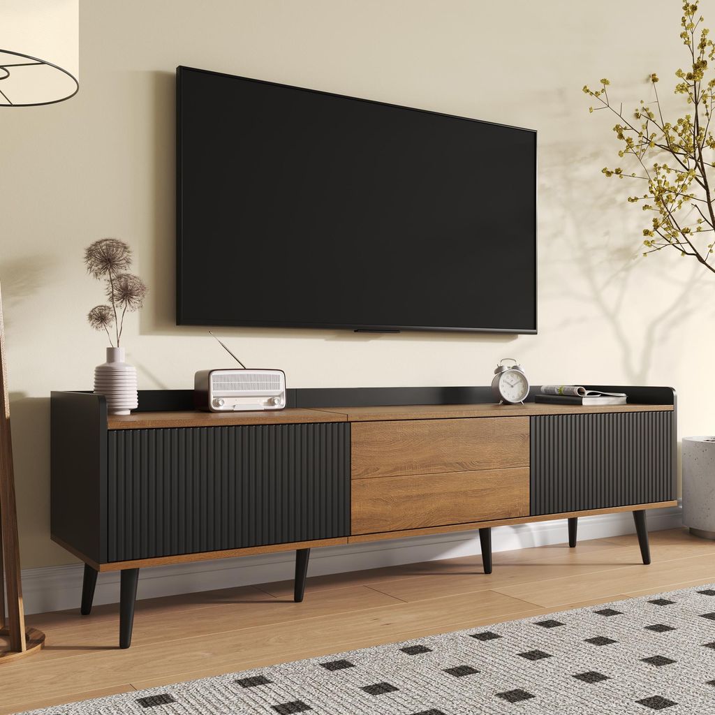 A modern living room scene featuring a TV stand with a television mounted above it.