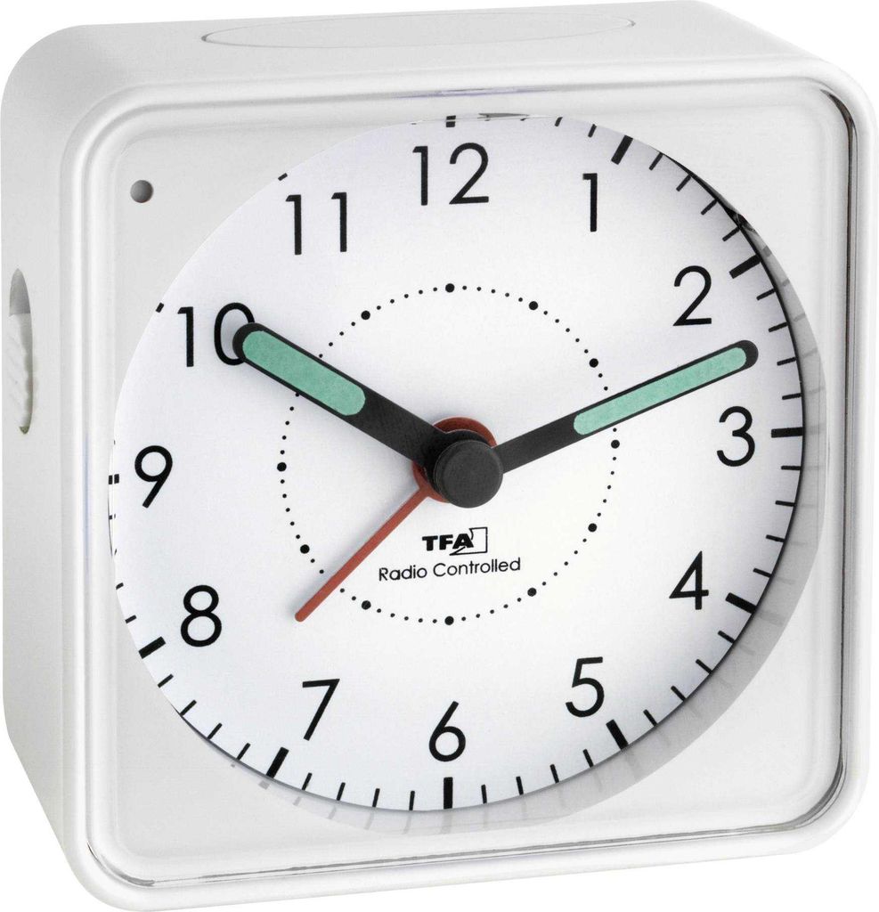 A white TFA alarm clock with a white face and black numbers.