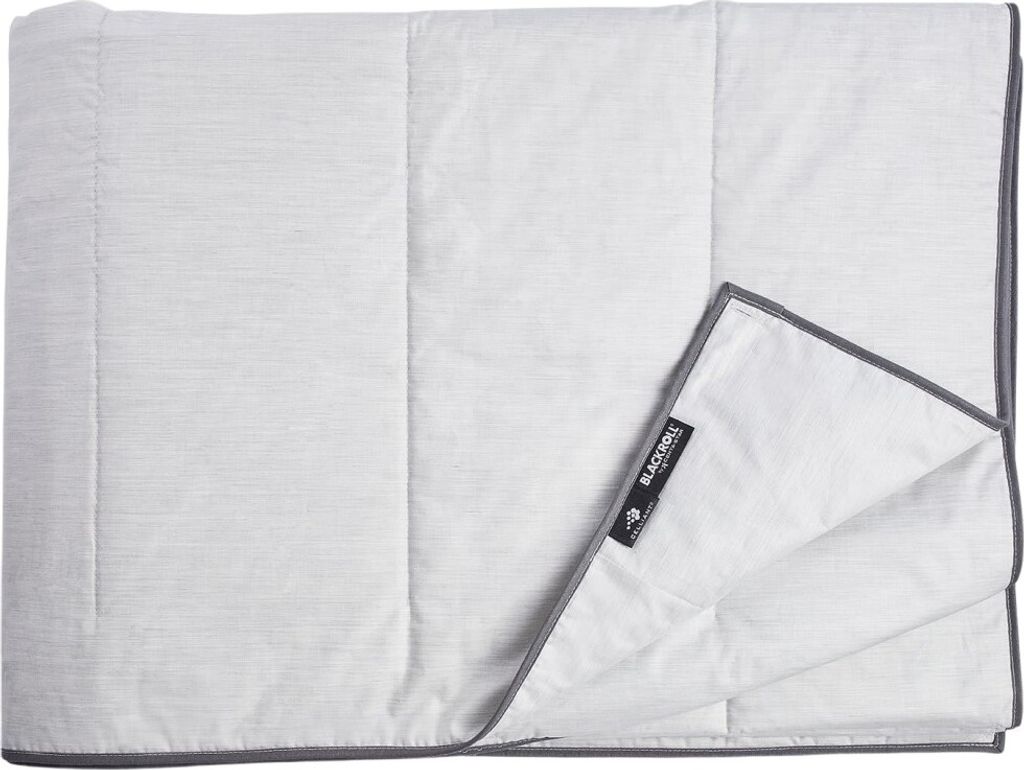 A folded blanket with a label attached.