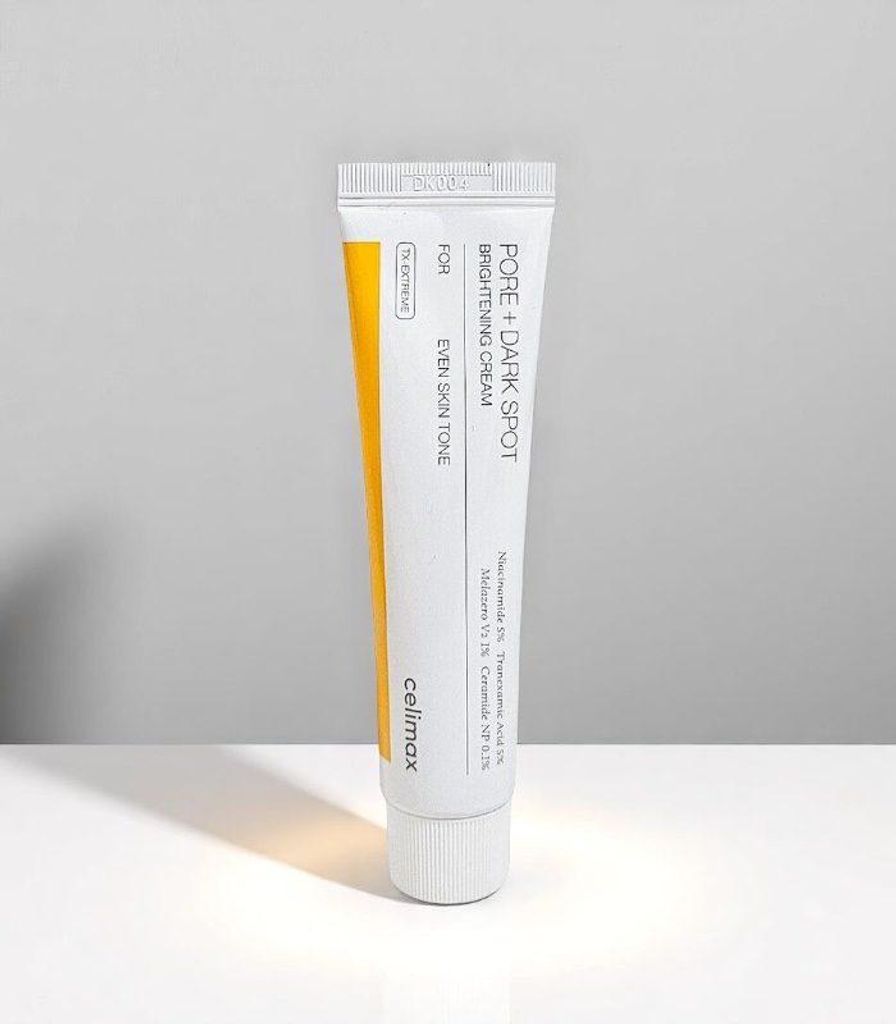 A product shot of a tube of cream against a neutral background.