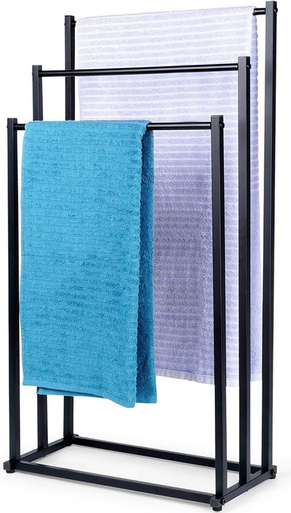 A black metal towel rack with three bars, holding three different colored towels.