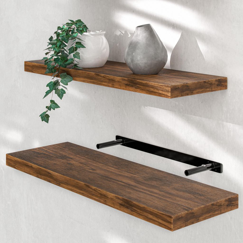 Two wooden shelves mounted on a white wall, with decorative items on the top shelf.