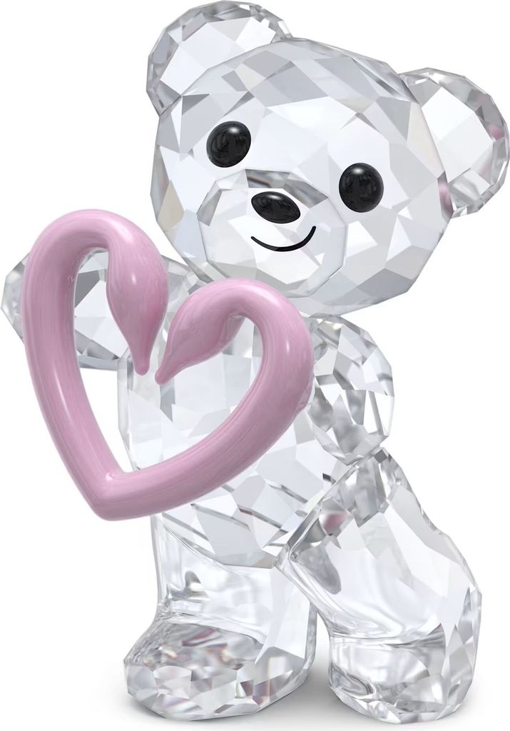A clear, professional studio shot of a crystal bear figurine holding a pink heart.