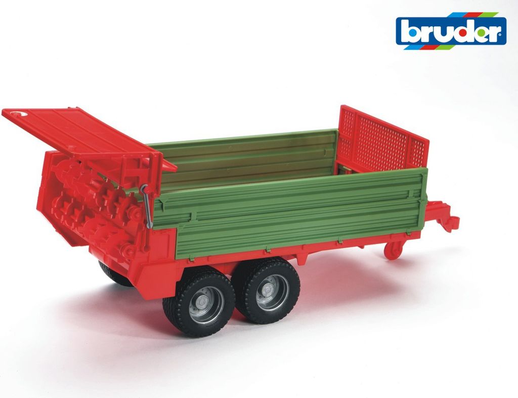 A toy trailer with a green cargo bed and red frame, shown from a side-angle on a white background.