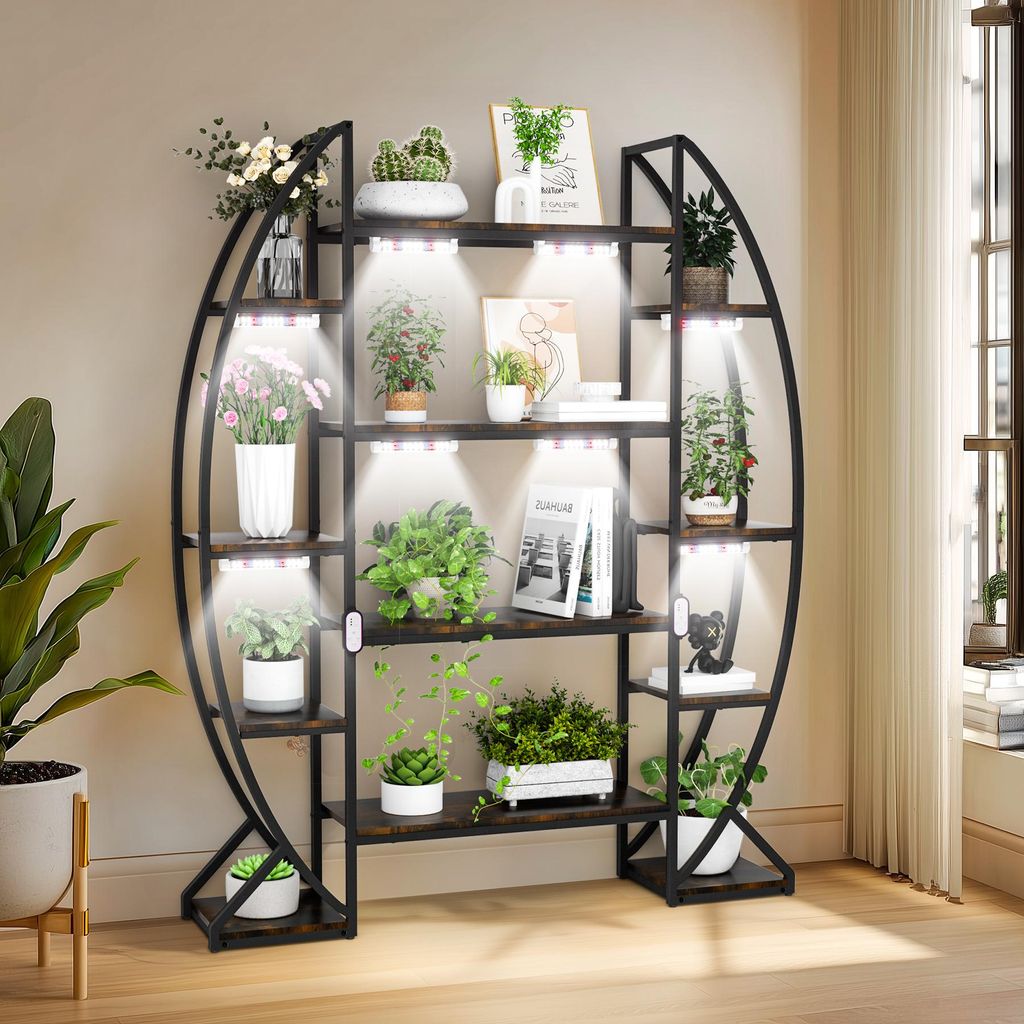 A multi-tiered plant stand with integrated grow lights, filled with various potted plants.