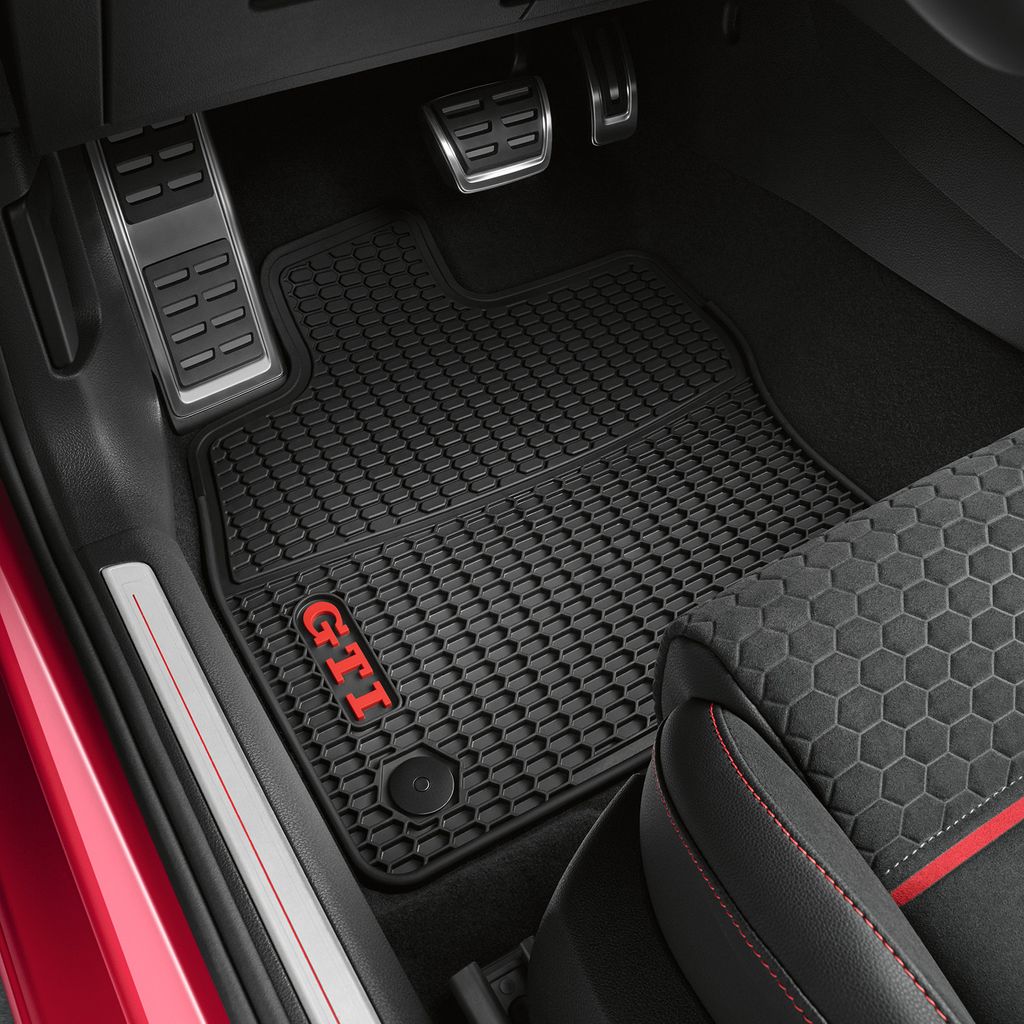 Interior view of a car's driver's side floor with custom floor mats.