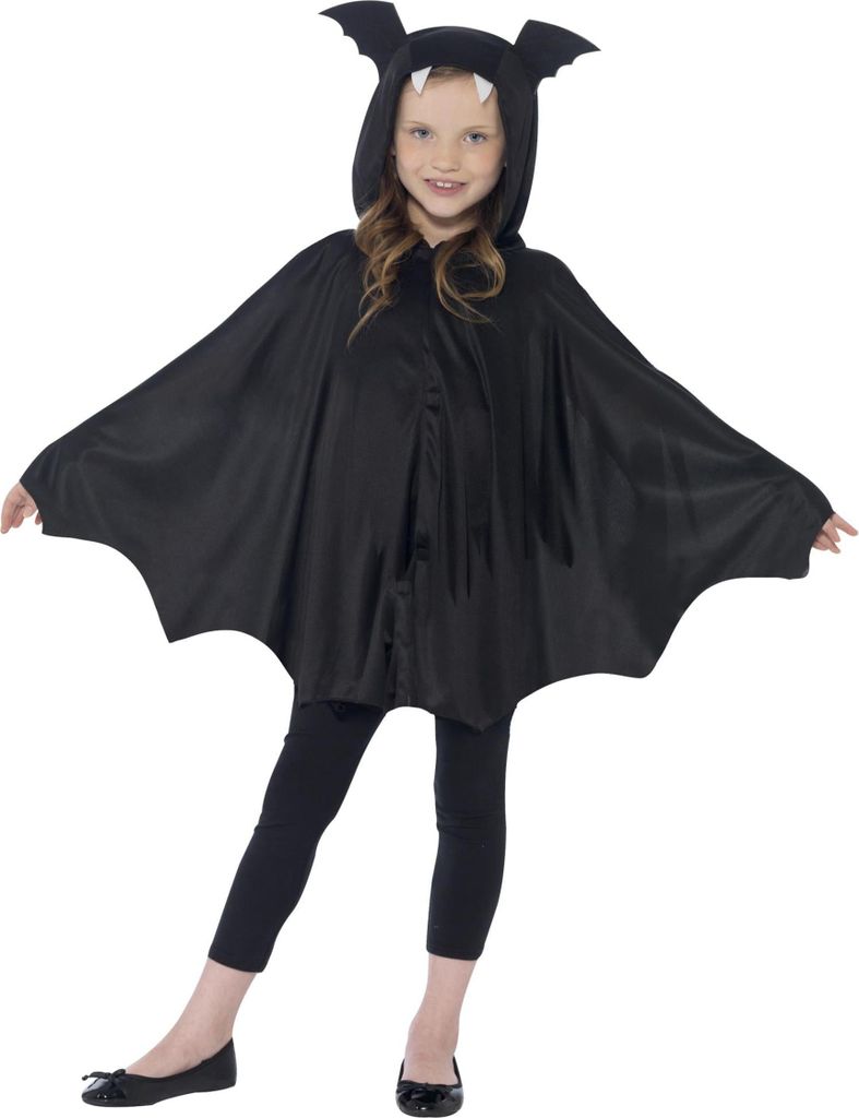A young girl wearing a black bat costume with wings and a hood with ears and fangs.