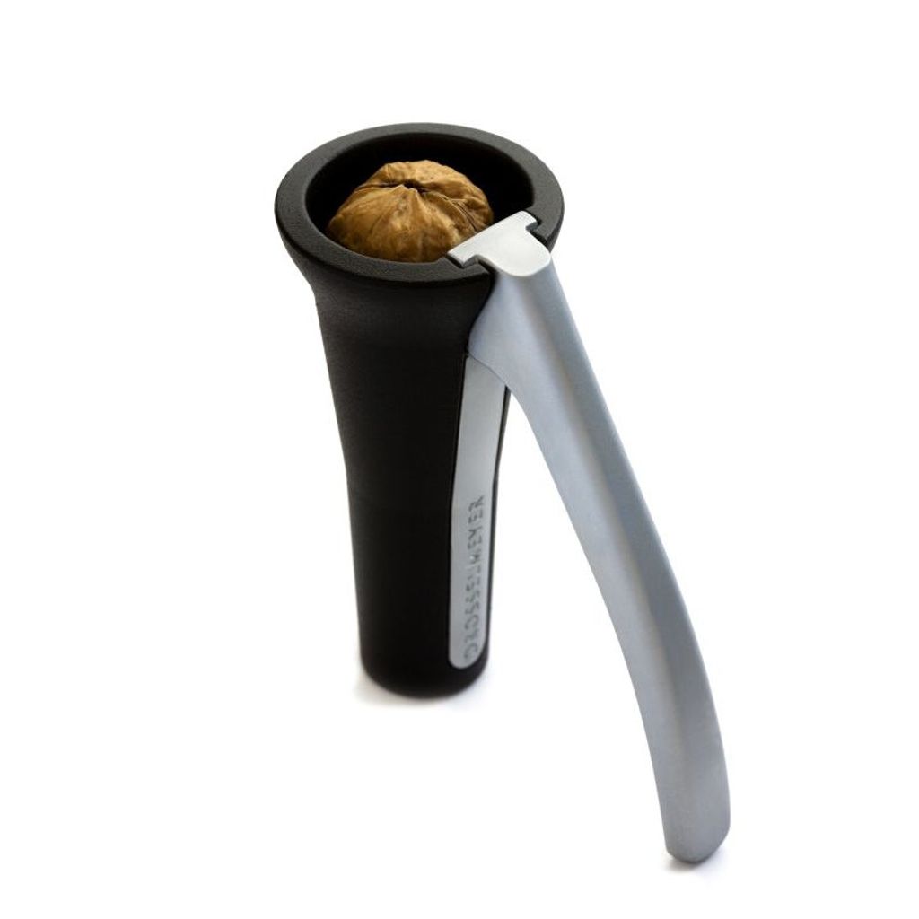 A nutcracker with a walnut inside, isolated on a white background.