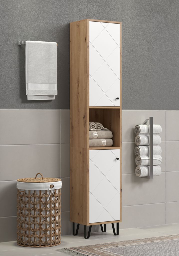 A tall, narrow bathroom cabinet with white and wood-tone finishes, standing next to a laundry basket and a towel rack.