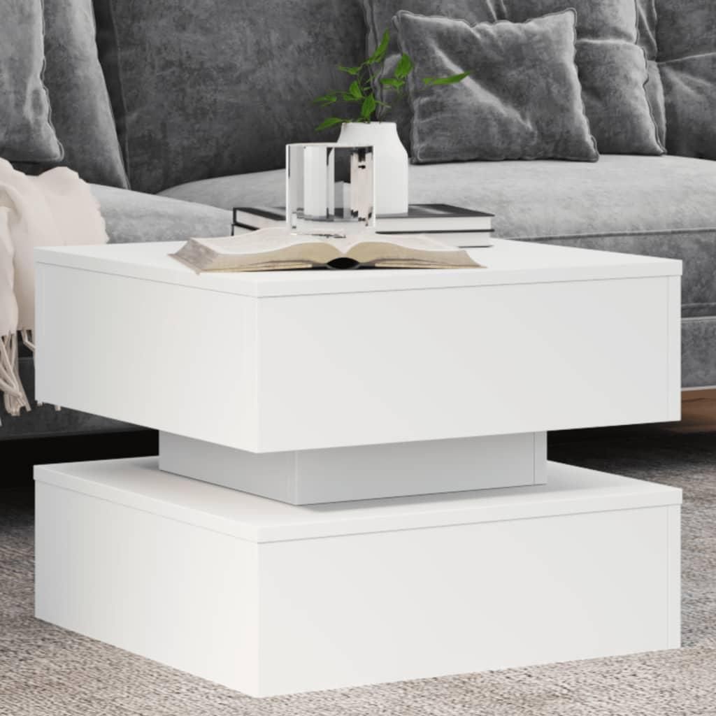 A white coffee table in a living room setting with a couch in the background.