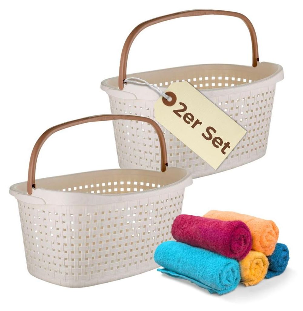 Two white laundry baskets with brown handles are shown, with a stack of rolled towels in colorful shades of pink, orange, blue, and yellow in the foreground. A tag on one of the baskets reads '2er Set'.
