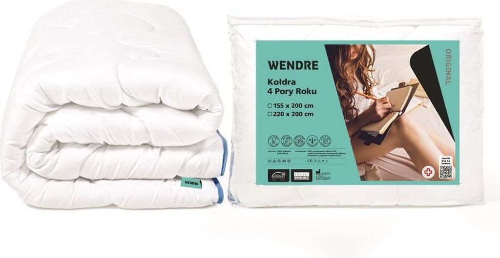 A folded white duvet is shown next to its packaging, which features a lifestyle image of a woman reading in bed.