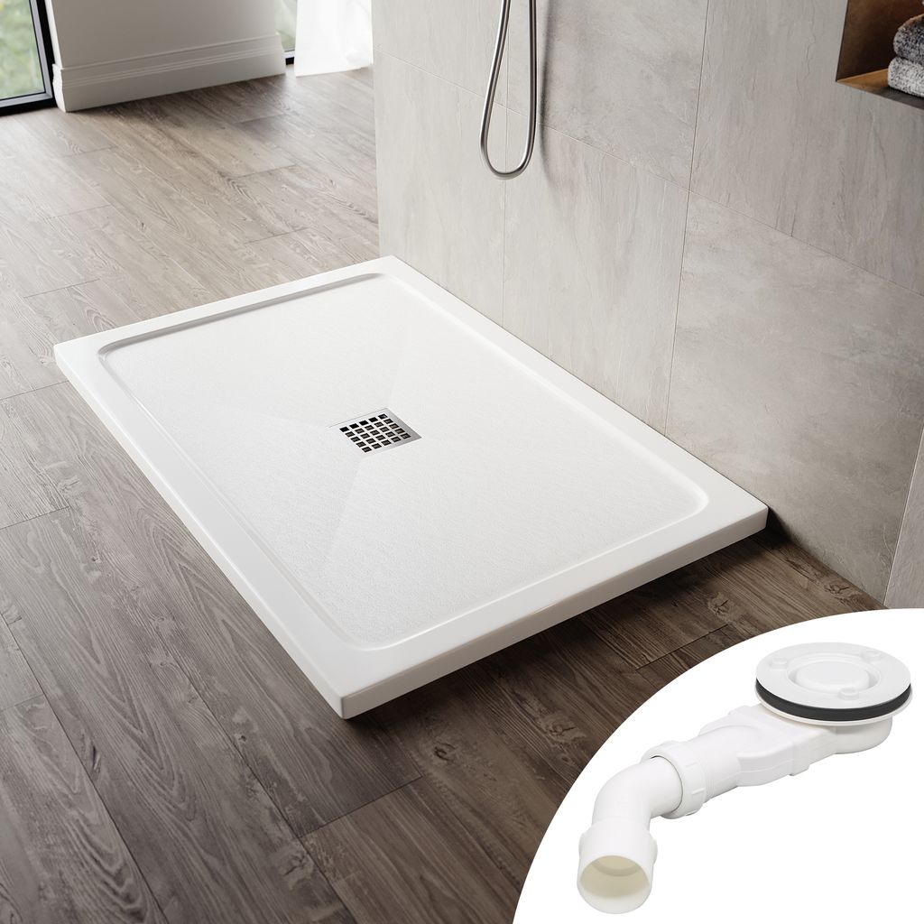 A white shower tray with a drain is shown on a wooden floor next to a tiled wall. A separate image of a drain assembly is in the bottom right corner.
