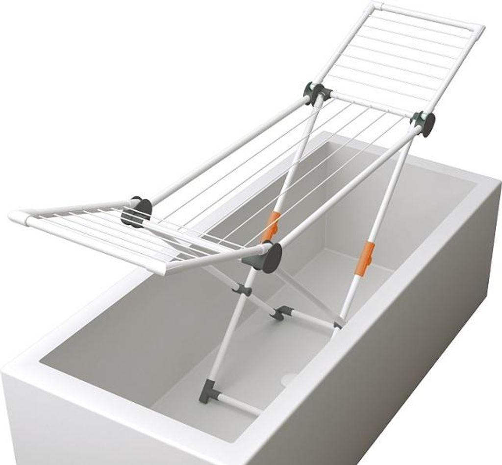 A white drying rack is placed over a white bathtub.