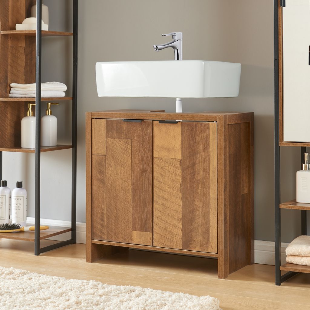 A bathroom vanity with a sink and faucet, next to a shelving unit.