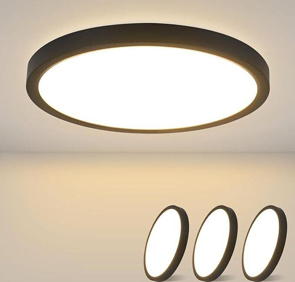 A close-up of a black LED ceiling light mounted on a white ceiling, with three smaller, similar lights shown in the foreground.