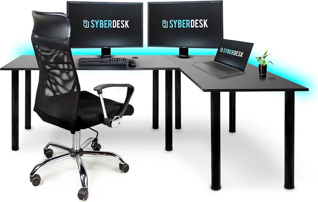 A black L-shaped desk with two monitors, a laptop, a keyboard, a mouse, and a black ergonomic chair, with blue LED lighting in the background.
