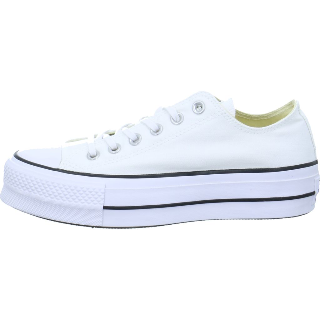 A side view of a white Converse sneaker with a platform sole.