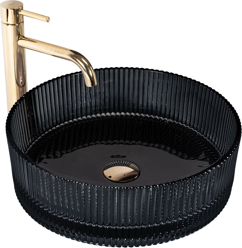 A black glass vessel sink with a gold faucet.