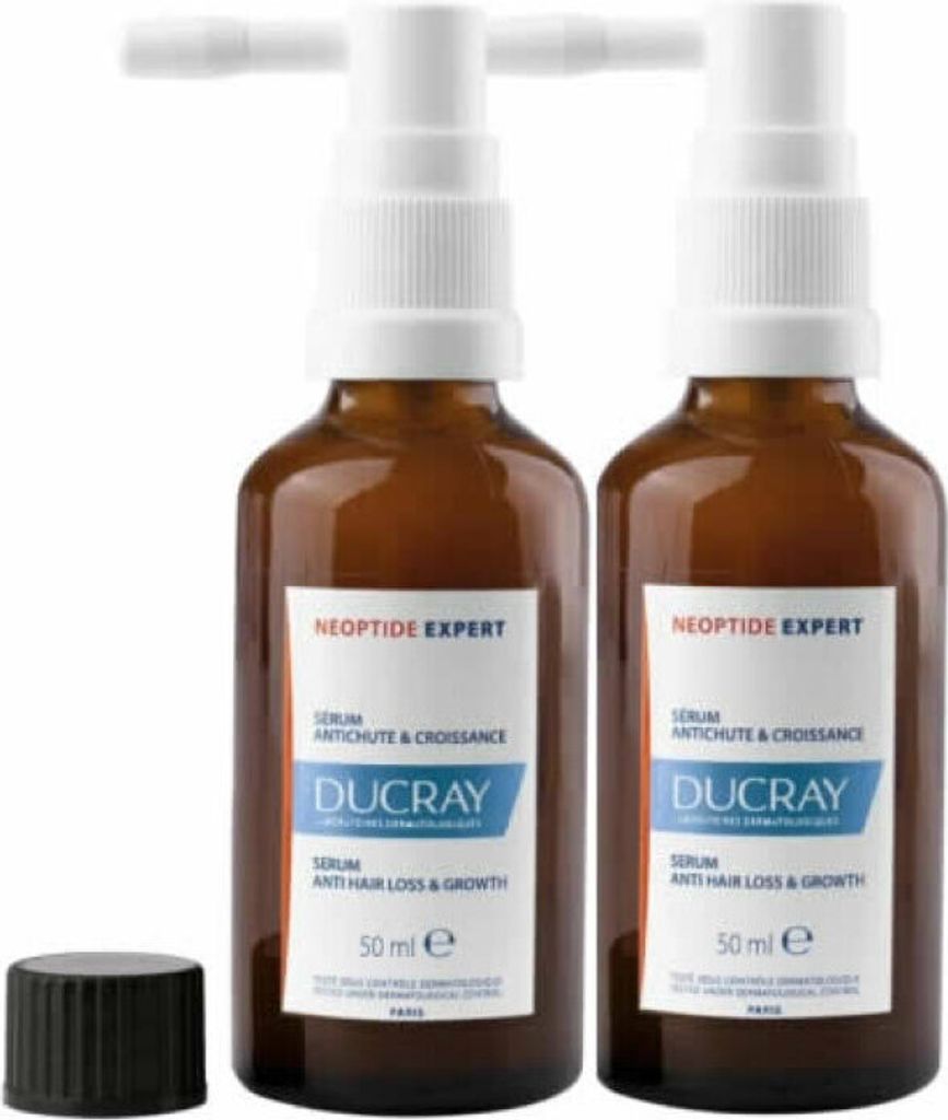 Two bottles of Ducray Neoptide Expert Serum Anti Hair Loss & Growth are displayed side-by-side on a white background, with a black cap to the left.