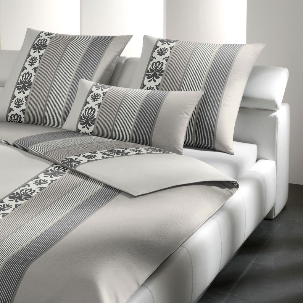 A neatly made bed with pillows and bedding.